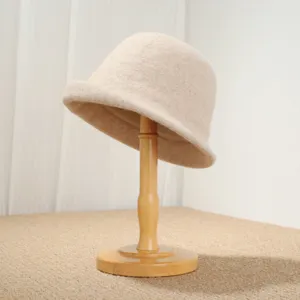 Close-up detail of retro wool felt cloche hat showing fine texture and rolled brim craftsmanship.
