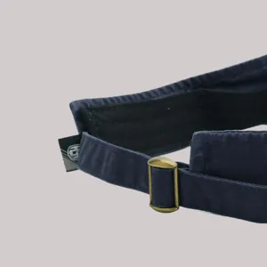 Close-up detail of the adjustable metal buckle and fabric strap on a navy sun visor.