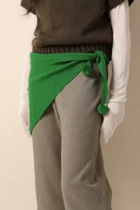 Green knitted triangular scarf with pom-poms, wool-blend winter fashion accessory.
