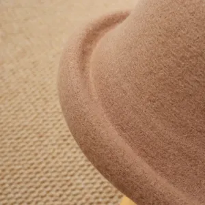 Close-up detail of the vintage rolled brim wool felt cloche hat, showing soft texture.