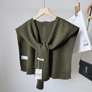 Dark green wool blend knitted shawl detail, stylish tied collar design, perfect for layering.