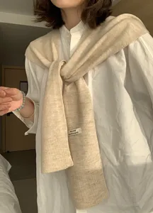Wool blend knitted shawl for women in beige, stylish knotted shoulder wrap for layered outfits.