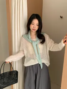Korean style hollow knit sweater with green scarf and grey pants outfit detail view