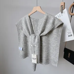 Grey wool blend knit shawl detail view, versatile layered knotted capelet for women.