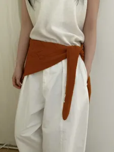 Pure wool hollow triangular scarf detail, stylish rust orange knit accessory for women.