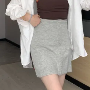 Grey knit mini skirt for women, high-waisted slim fit casual autumn winter apparel.