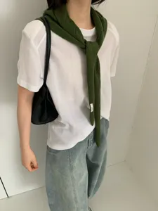 Green knit scarf shawl worn with white t-shirt, stylish autumn and winter warm accessory.
