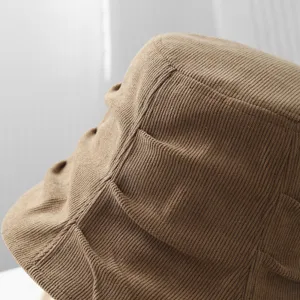 Knit bucket hat detail showing textured ribbed brown fabric, stylish casual autumn wear.