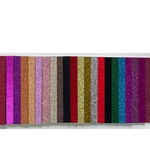 Detailed display of colorful glitter cardstock paper samples for wedding invitations