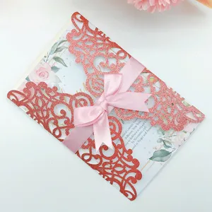 Elegant laser cut lace wedding invitation with coral glitter cover and pink ribbon bow