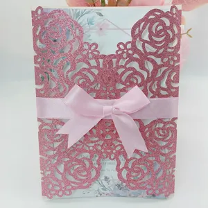 Elegant pink laser cut wedding invitation card with glitter rose lace and pink satin bow.
