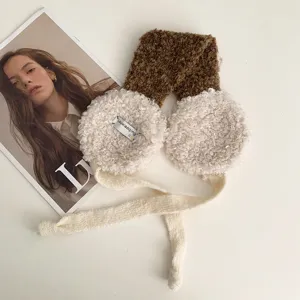 Detail view of winter warm lamb fleece earmuffs with knit ties, cozy outdoor cold weather gear.