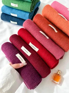 Solid color 100% wool knitted winter warm fashion scarf closeup view and soft fabric details