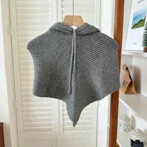 Vue détaillée de la cagoule en tricot gris avec capuche et tour de cou avec cordon de serrage.