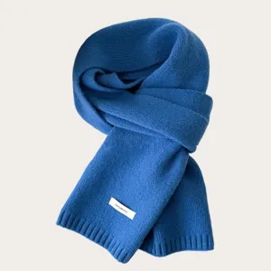 Blue knit wool scarf detailed view showcasing soft texture and warm winter accessory design.