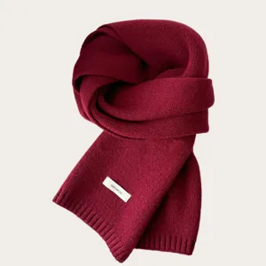 Detailed view of the dark red knitted wool scarf, showcasing fine texture and soft material.