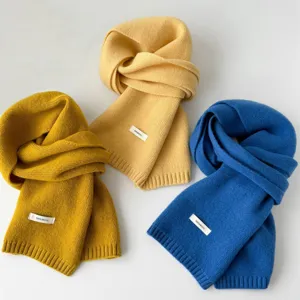 Close-up detail of soft winter solid wool knit scarves in multiple colors, warm neckerchief.