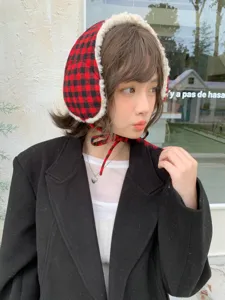 Plush plaid earmuffs detail shot, soft white fleece lining and red black pattern, warm winter style.