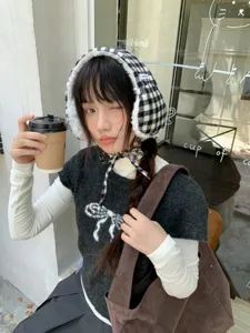 Thickened warm plush checkered earmuffs for women, cozy winter ear warmers with soft lining.
