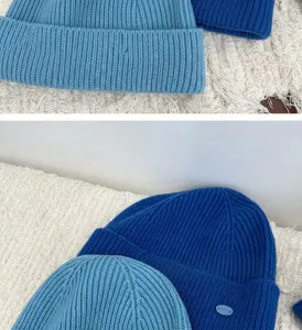 Blue knit hat and scarf set, ribbed wool winter warm accessory close-up detail shot.