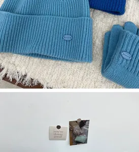 Blue knit beanie and gloves set with ribbed texture, cozy winter warm accessories.
