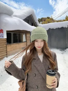 Cozy green knitted beanie for women winter outdoor wear warm soft wool ski cap detail view