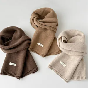 Detailed view of soft wool knitted winter scarf set in neutral colors for cold weather.