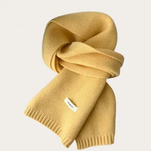 Yellow pure wool knitted scarf for women, warm winter neckerchief, soft texture detail.