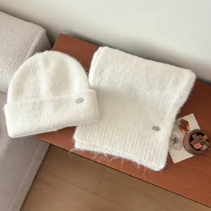White knitted beanie hat and scarf set, cozy winter warm wool blend accessories.