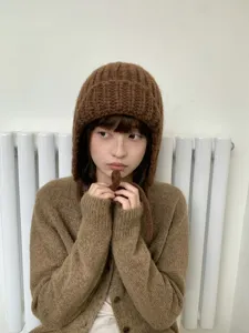 Cozy brown chunky knit balaclava hat detail, warm winter earflap design for women.
