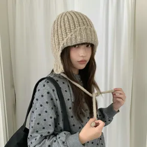 Chic thick knit balaclava hat for women, cozy winter earflap beanie with ties for warmth.