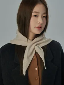 Primo piano della sciarpa triangolare in 100% lana morbida indossata dalla modella.