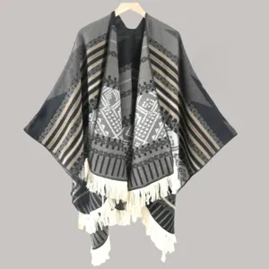 Details of the ethnic style knitted poncho shawl with fringe and geometric patterns in gray.