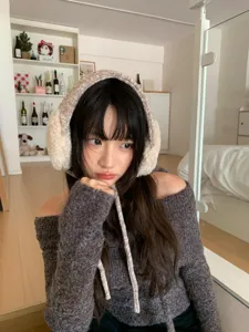 Detailed view of women autumn winter warm knitted furry earmuffs with cute long ties.