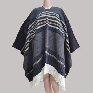 Detailed view of the ethnic style knitted poncho with fringe hem and warm striped pattern.