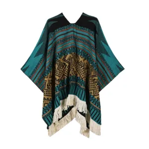 Bohemian ethnic style knitted poncho cape with geometric patterns and fringe hem for women.