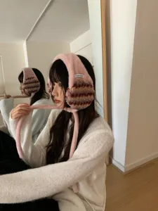 Pink plush winter earmuffs with cute long straps, soft warm ear warmers for women cold weather.