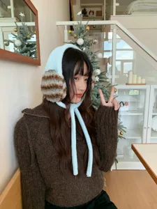 Plush winter earmuffs detail, soft fuzzy ear warmers with cute ties, cozy cold weather accessory.