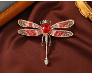 Detailaufnahme einer wunderschönen Libellen-Brosche mit roten Zirkonia und funkelnden Strasssteinen.