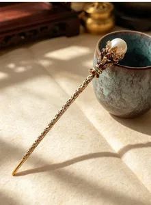 Vintage pearl metal hair stick detail, elegant bronze hairpin for classic hairstyles and hair buns.