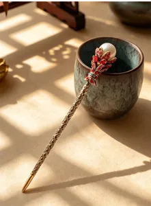 Vintage Chinese hair stick detail featuring pearl and red rhinestones on bronze metal stem.