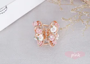 Detail view of vintage alloy butterfly hair claw clip adorned with charming sweet pink and white roses.