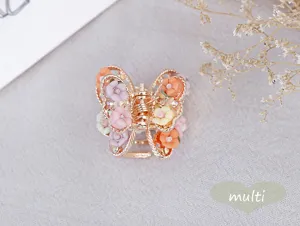 Detailed view of vintage alloy butterfly hair claw clip adorned with colorful soft pottery roses.