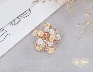 Detail shot of the vintage polymer clay rose mini hair claw, featuring alloy and rhinestones.