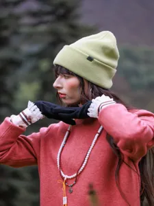 Outdoor wool knit beanie detail shot, featuring cozy rolled brim and soft texture for winter.