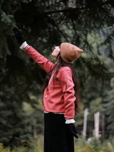 Detailed shot of women's warm wool knit beanie hat, brown rolled cuff design for outdoor travel.