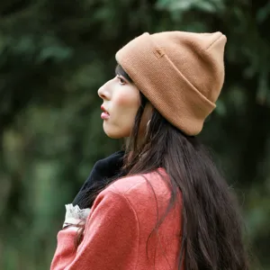Women winter warm pure wool knit beanie hat, solid color cuffed design for outdoor travel.
