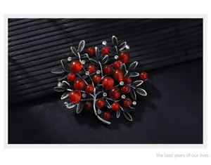 Vintage silver-tone branch brooch with red beads and crystal accents for women fashion.
