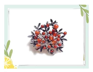 Vintage gemstone branch brooch detail, elegant antique silver tone costume jewelry accessory.