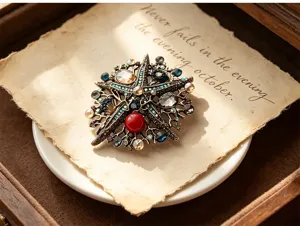 Detail shot of a vintage alloy rhinestone starfish brooch placed on retro parchment paper.